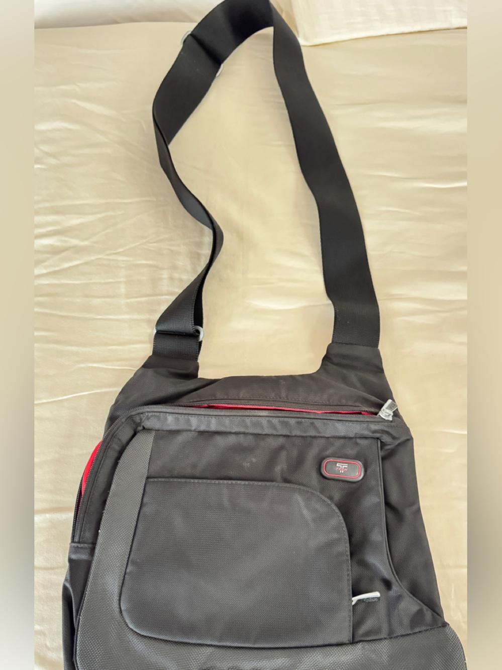 Tumi Black Travel Sling Bag with Red Trim